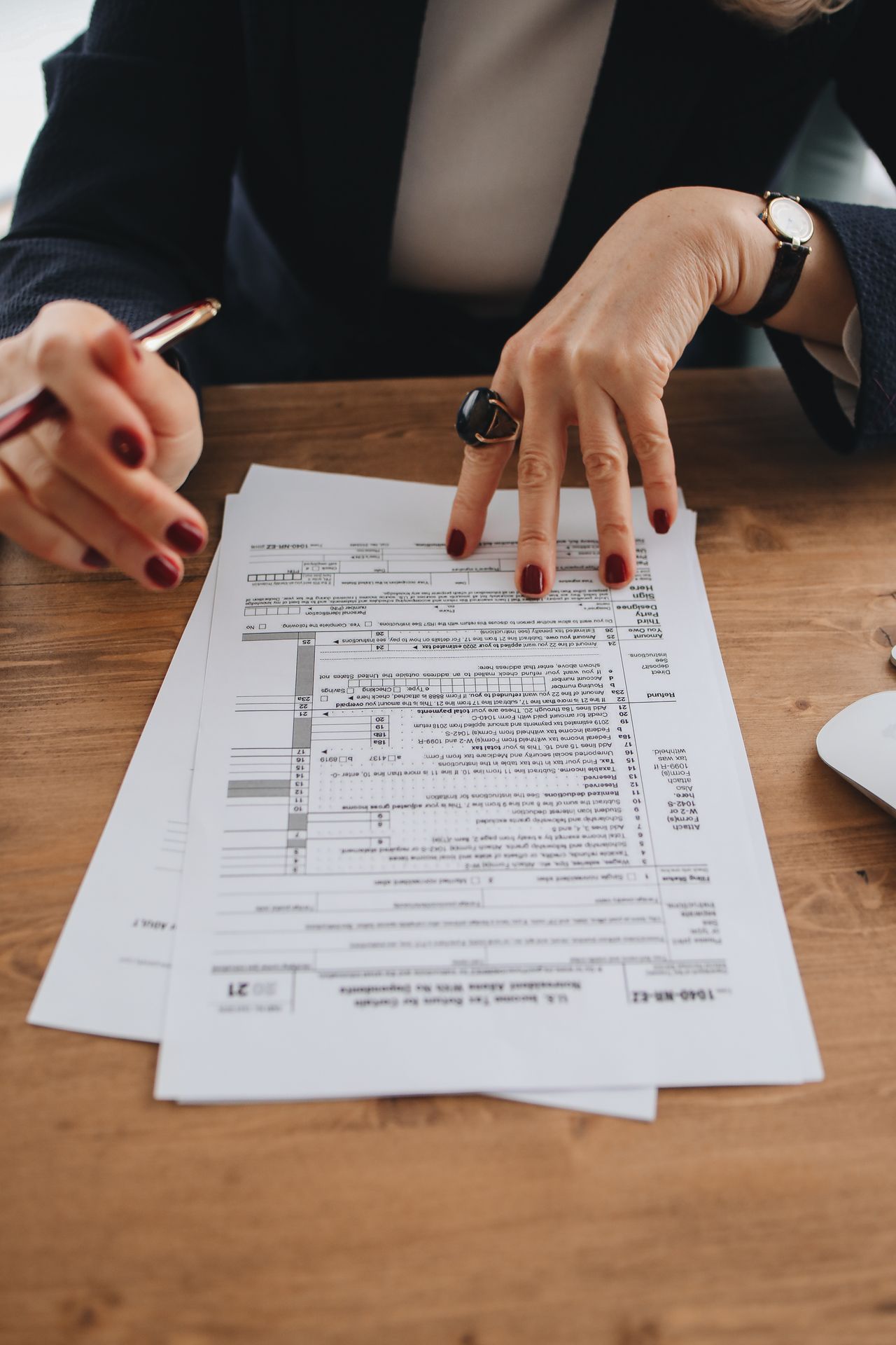 Employee reviewing paycheck withholding in SCL Tax Services in Bronx, NY. 10470