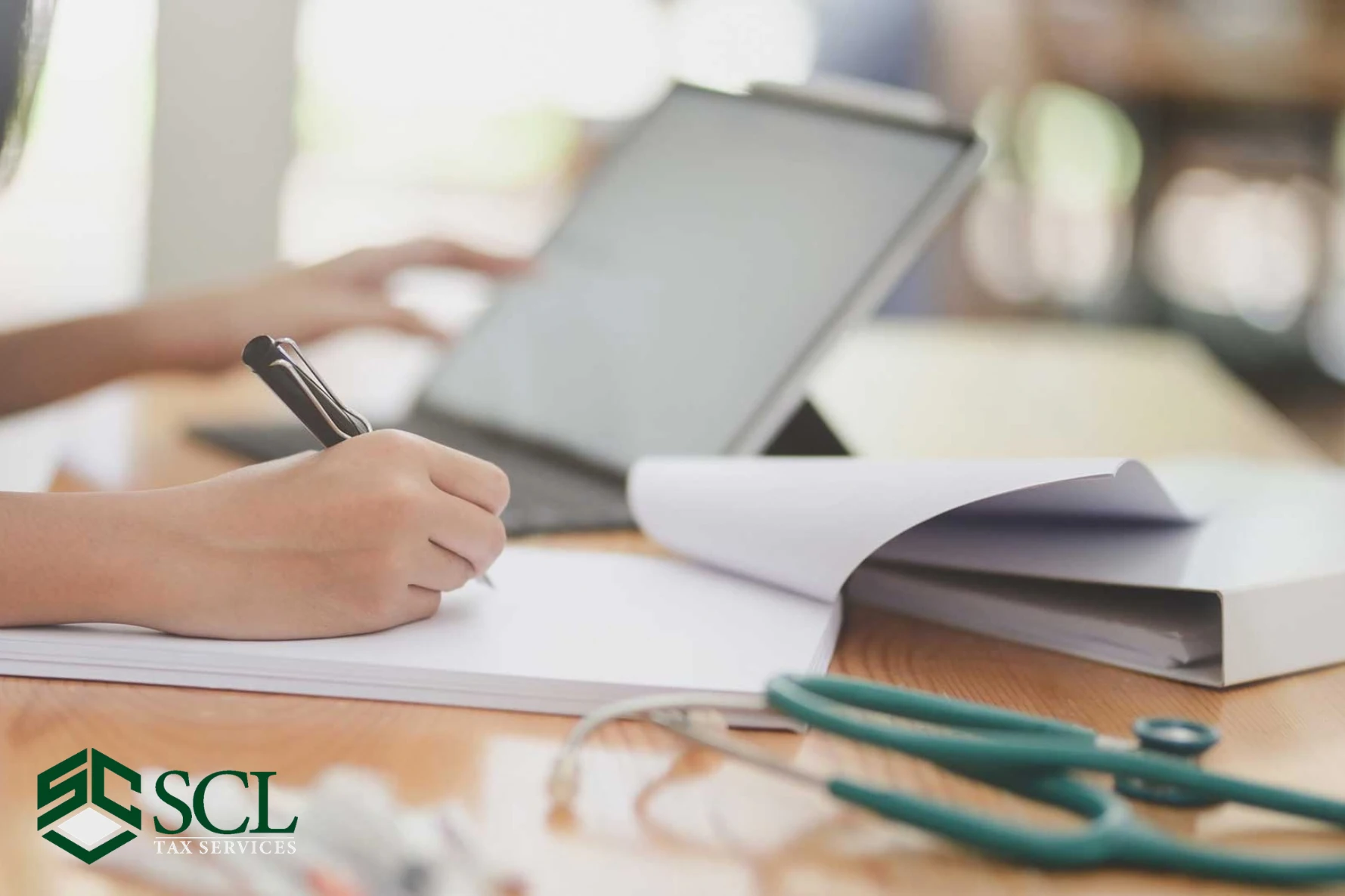 Tax specialist writing article at SCL Tax Services in Bronx, NY. 10470