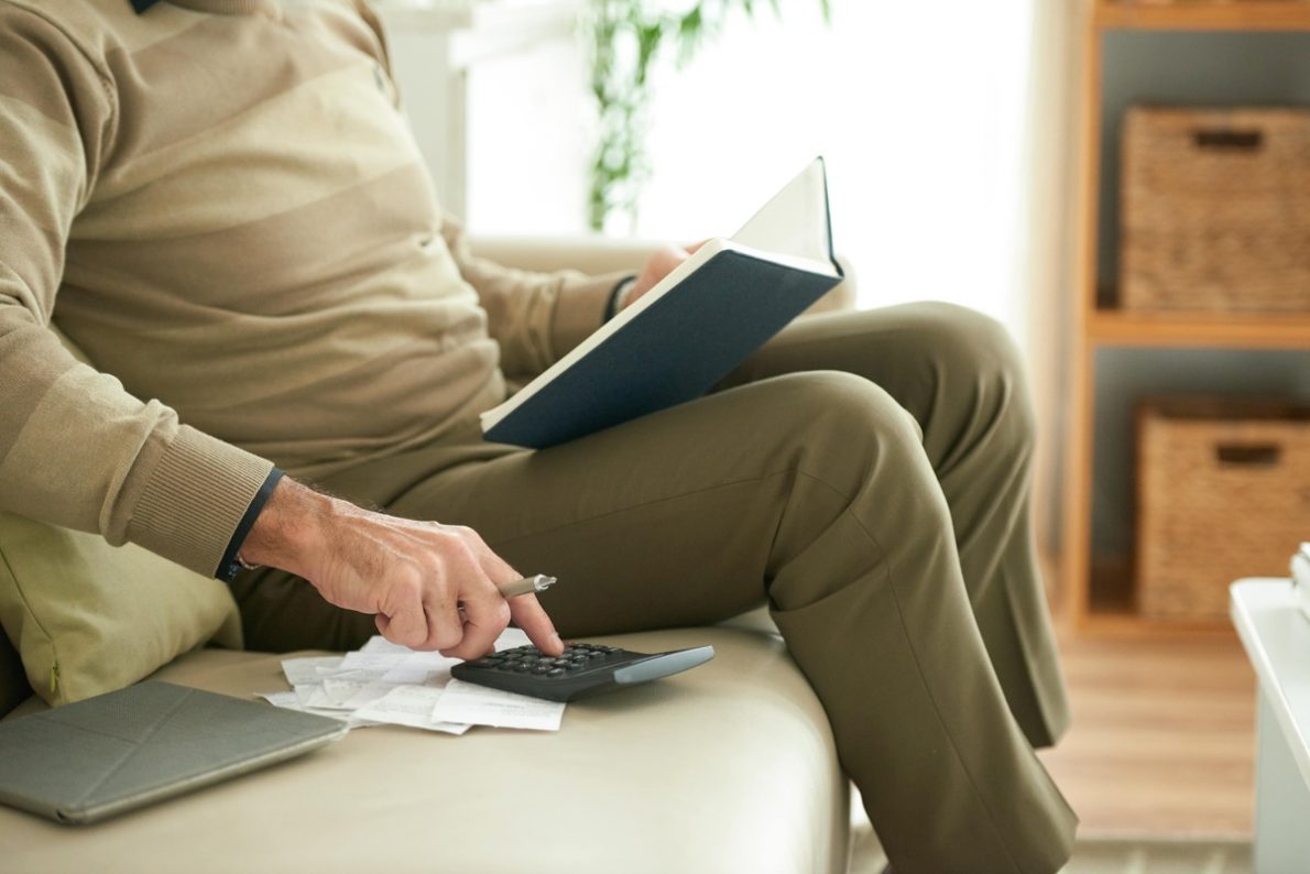 A man using calculator to planning his retirement In & Near Bronx, NY