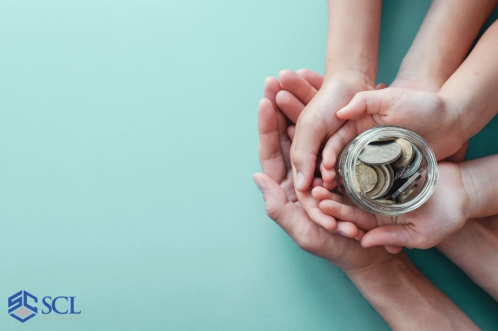 Child and adult holding money jar for donation in and near Bronx New York