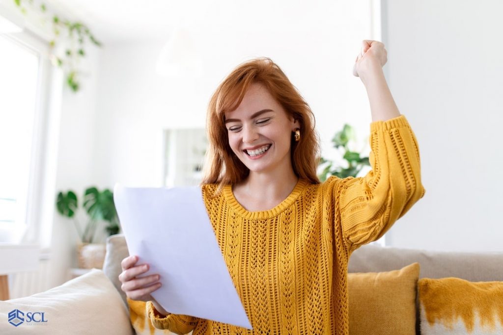 An excited woman getting tax refund check soon in and near Bronx