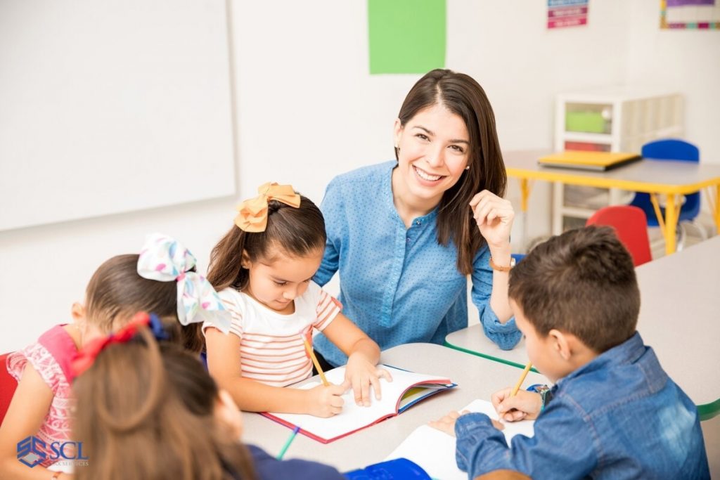 Happy teacher in kindergarten class in and near Bronx, NY