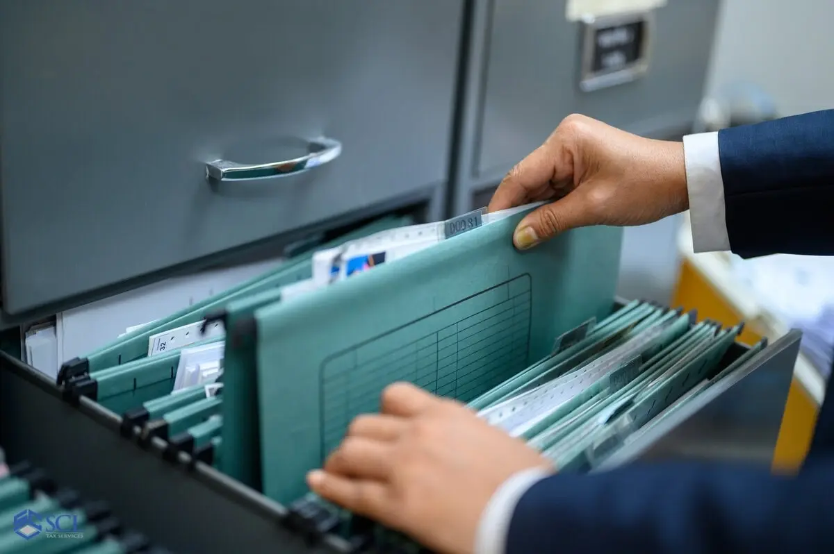 A man categorizing files with tax accountant for tax season in Bronx, NY