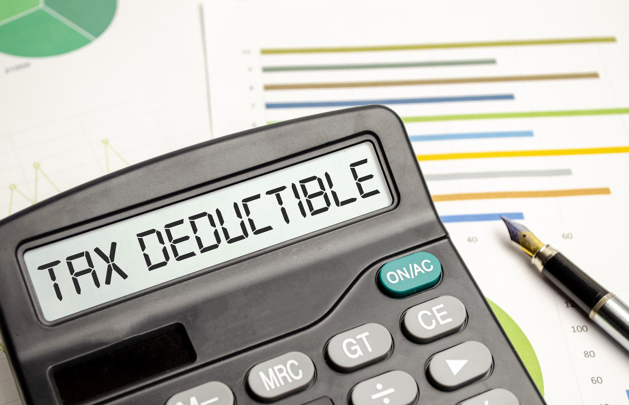 Tax deductible calculator on a desk: A device used to calculate tax deductions, placed on a desk for easy access and convenience.