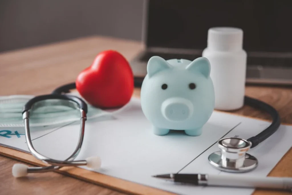 Medical Insurance Concept With Piggy Bank And Stethoscope On Wooden Desk
