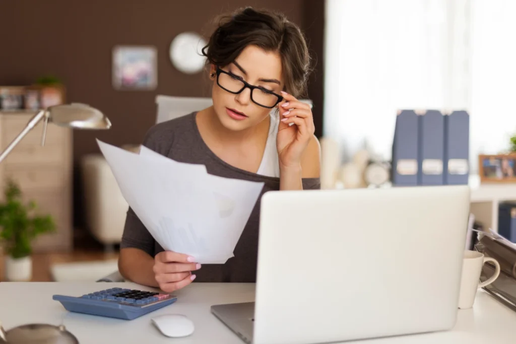 Young woman working hard on taxes in Brox