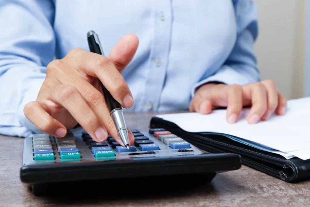 Closeup of marketing expert using calculator
