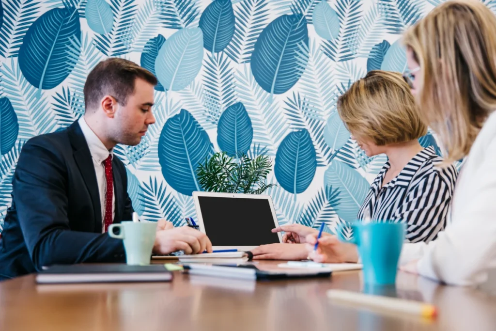 People sitting and coworking at laptops, discussing the topic of Missing the Tax Deadline