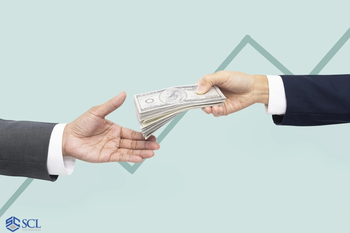 hand holding cash as a tax return