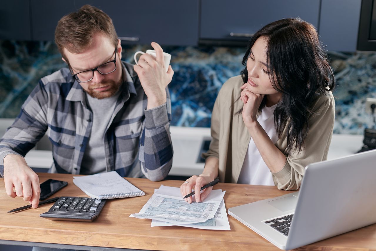 Tax professional reviewing financial records and discussing legitimate tax resolution options with a client
